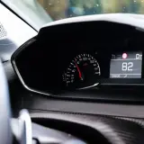 Tableau de bord d'une voiture affichant 82 km/h. Pour savoir si une voiture est gagée, vérifiez son historique.