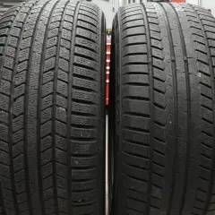 Deux pneus côte à côte : l'un avec un profil profond et lamellisé pour l'hiver, l'autre plus lisse. Apprenez à reconnaître pneu hiver et 4 saisons.