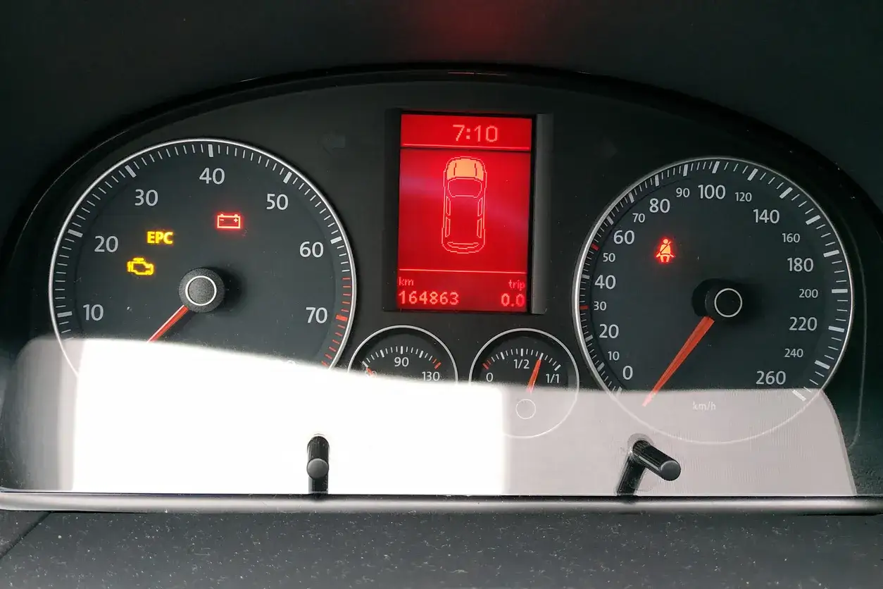 Tableau de bord Volkswagen avec voyant EPC allumé, indiquant un problème moteur. La batterie est également déchargée.